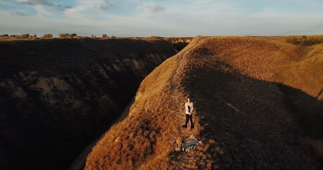 wedding ceremony of a girl and a guy on high hills near the sea