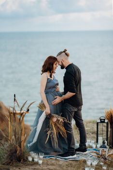 wedding ceremony of a girl and a guy on high hills near the sea