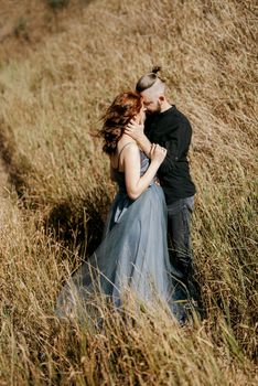 pregnant girl and boyfriend on high hills near the sea