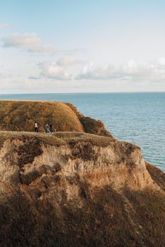 wedding ceremony of a girl and a guy on high hills near the sea