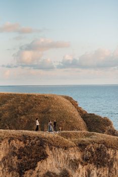 wedding ceremony of a girl and a guy on high hills near the sea