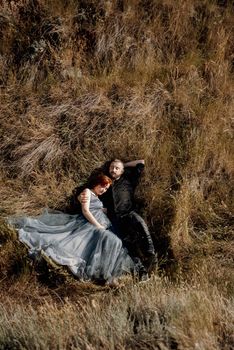 pregnant girl and boyfriend on high hills near the sea