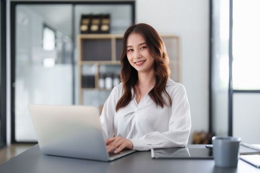 Beautiful Business woman working at home office and analyze financial report document. Accounting and Finance concept.