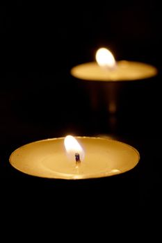 Three burning candles on the table close up