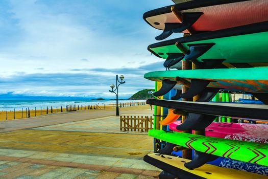 Surfboards on the background of the Atlantic coast of Spain. Surfboard rental