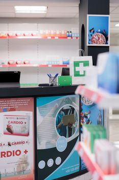 Empty pharmacy filled with pharmaceutical products and pills ready for customers to come and buy medical treatment. Green screen mock up chroma key supplements packages standing on counter desk