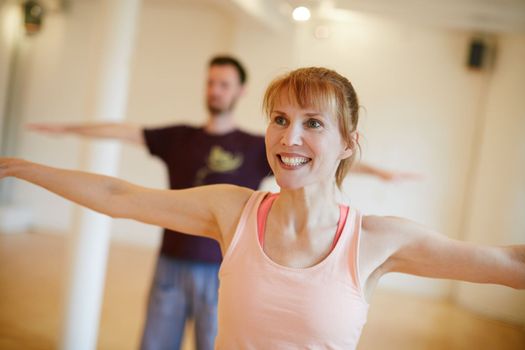 Living a balanced lifestyle. two people doing yoga indoors