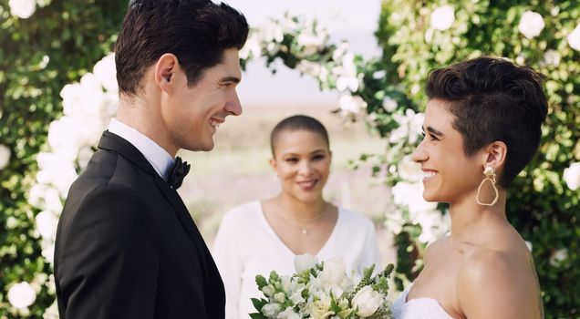 You make me such a happy man. an affectionate young couple smiling at each other while saying their vows on their wedding day