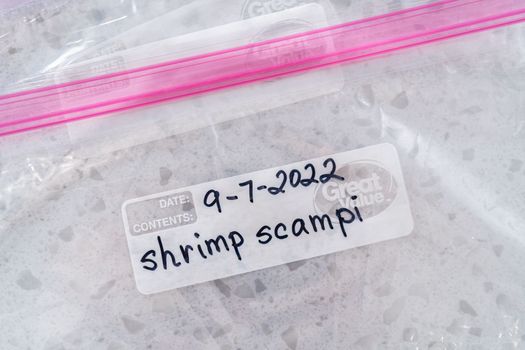Colorado Springs, Colorado, USA-September 7, 2022-Empty plastic bags to package homemade frozen shrimp scampi meal prep.