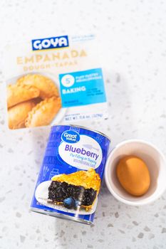 Denver, Colorado, USA-August 15, 2022-Measured ingredients in glass mixing bowls to make sweet empanadas with blueberries.