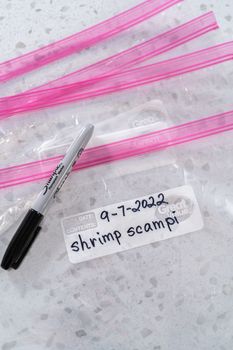 Colorado Springs, Colorado, USA-September 7, 2022-Empty plastic bags to package homemade frozen shrimp scampi meal prep.