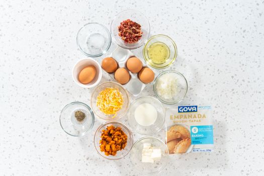 Denver, Colorado, USA-August 10, 2022 Flat lay. Measured ingredients in glass mixing bowls to make breakfast empanadas with eggs and sweet potato.