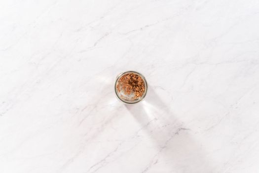 Day 1. Flat lay. Growing organic sprouts in a mason jar with sprouting lid on the kitchen counter.
