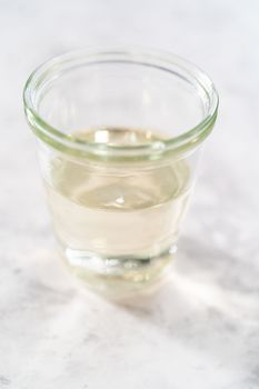 Freshly made simple syrup in a small glass jar.
