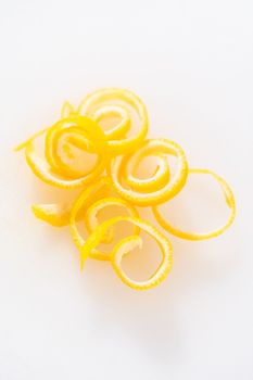 Preparing lemon swirls from the organic lemon to decorate the cocktail.