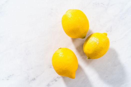 Preparing lemon swirls from the organic lemon to decorate the cocktail.