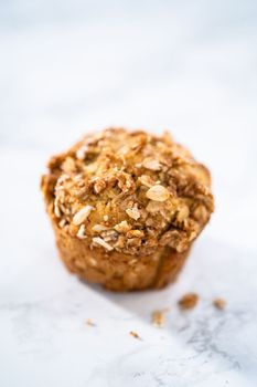 Freshly baked banana oatmeal muffins with oatmeal sugar topping.