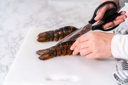 Preparing raw lobster tails to make garlic lobster tails.