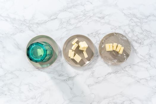 Flat lay. Softened sticks of unsalted butter on the counter.