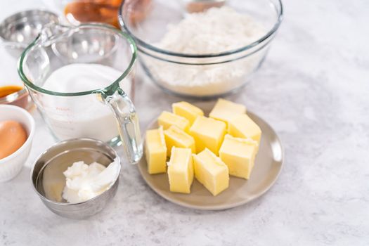 Measured ingredients in a glass mixing bowls to bake sweet pumpkin bread.