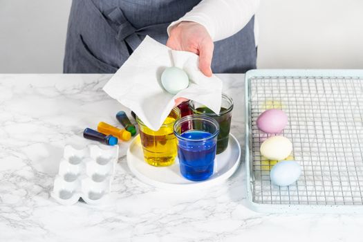 Coloring hard-boiled white eggs with natural food coloring.