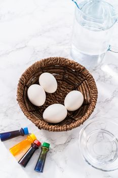 Coloring hard-boiled white eggs with natural food coloring.