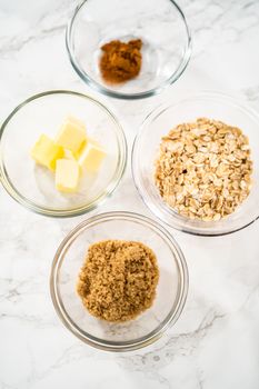 Measured ingredients in glass mixing bowls to bake banana oatmeal muffins.