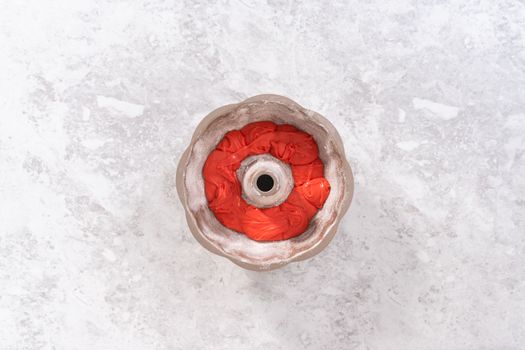 Flat lay. Filling bundt cake pan with red, white, and blue cake dought to bake July 4th bundt cake with chocolate stars.