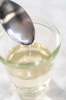 Freshly made simple syrup in a small glass jar.