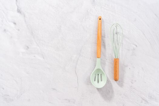 Flat lay. Silicone cooking utensils with wooden handle.