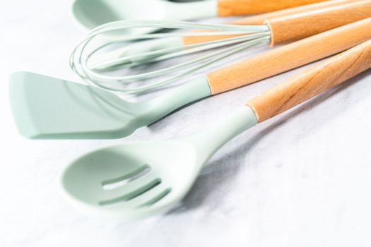 Silicone cooking utensils with wooden handle.