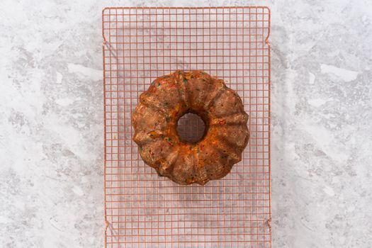 Flat lay. Cooling freshly baked funfettti bundt cake on a wire rack.