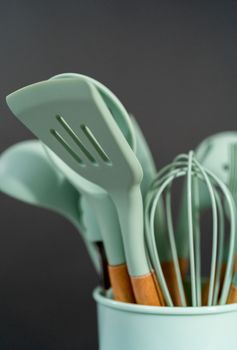 Silicone cooking utensils with wooden handle.