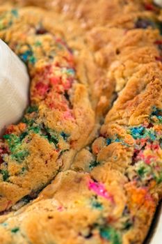 Close up view. Cooling freshly baked funfettti bundt cake on a wire rack.