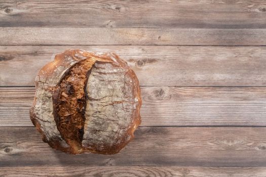 Flat lay. Freshly baked sourdough rye loaf of bread.