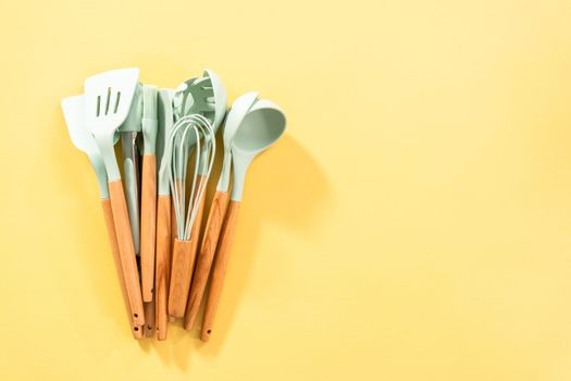 Flat lay. Silicone cooking utensils with wooden handle.