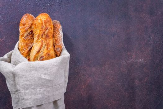 Flat lay. Freshly baked small French baguette bread.