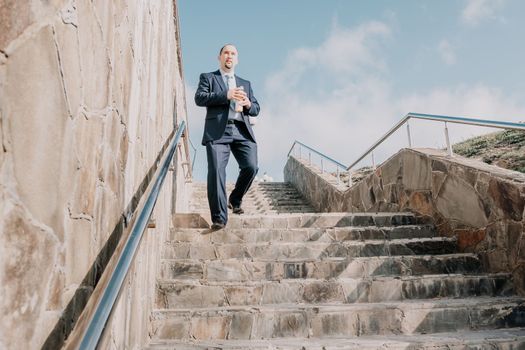 Business executive with briefcase going down the stairs.