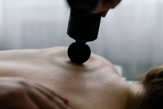 Young fat woman getting massage treatment in a day spa cabinet.