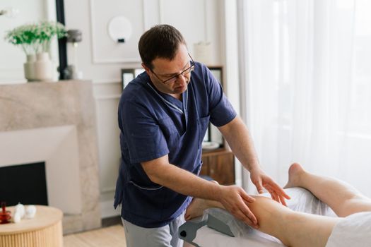 Young fat woman getting massage treatment in a day spa cabinet.