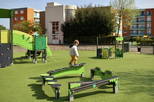 Boy playing on the playground in Europe