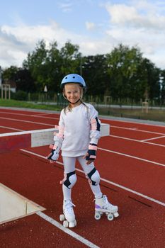 Girl in vintage white roller skates and a helmet at the stadium