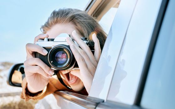 Camera, car and road trip of a woman excited about holiday, adventure and motor travel transport. Photography of a happy person in transportation ready for vehicle traveling and summer vacation.