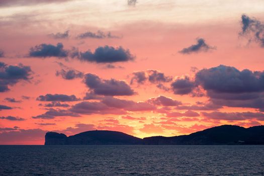 amazing red sunset on the giant that sleeps in Alghero, Sardinia, Italy