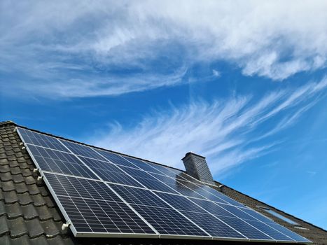 Solar panels producing clean energy on a roof of a residential house