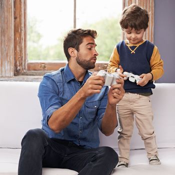 Press this button to jump higher. A handsome father and his cute son playing a video game together
