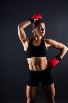Young woman athletic female MMA fighter is training. Concept of sport, action, healthy lifestyle.