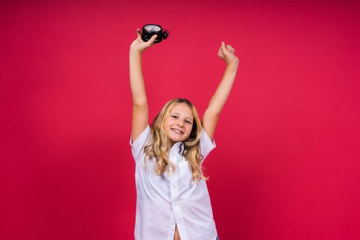 Young Girl holding antique clock over red background