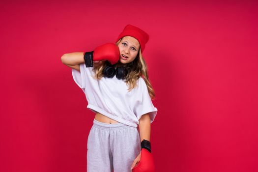 Little girl wearing red boxing gloves, studio shot, sport conception