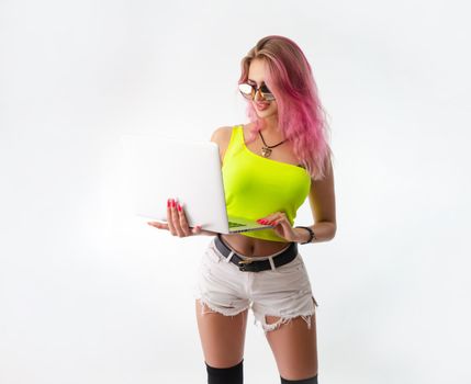 sexy girl in bright summer clothes with a laptop on a white background copy paste